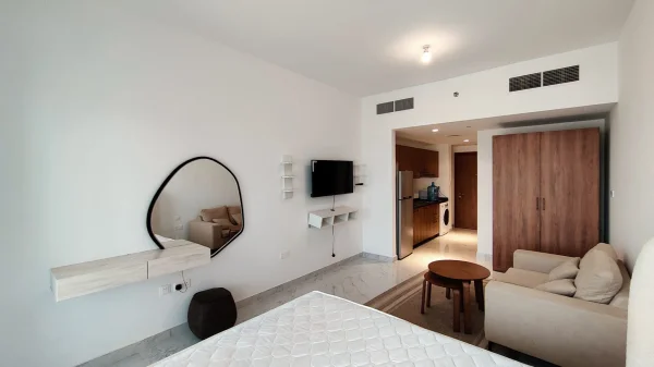 a glass building with a reflection of clouds in the windows